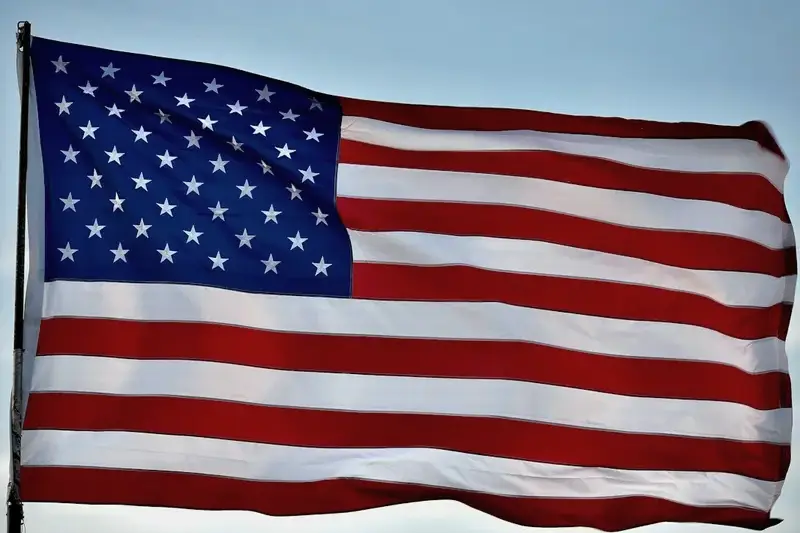 American flag waving against a blue sky